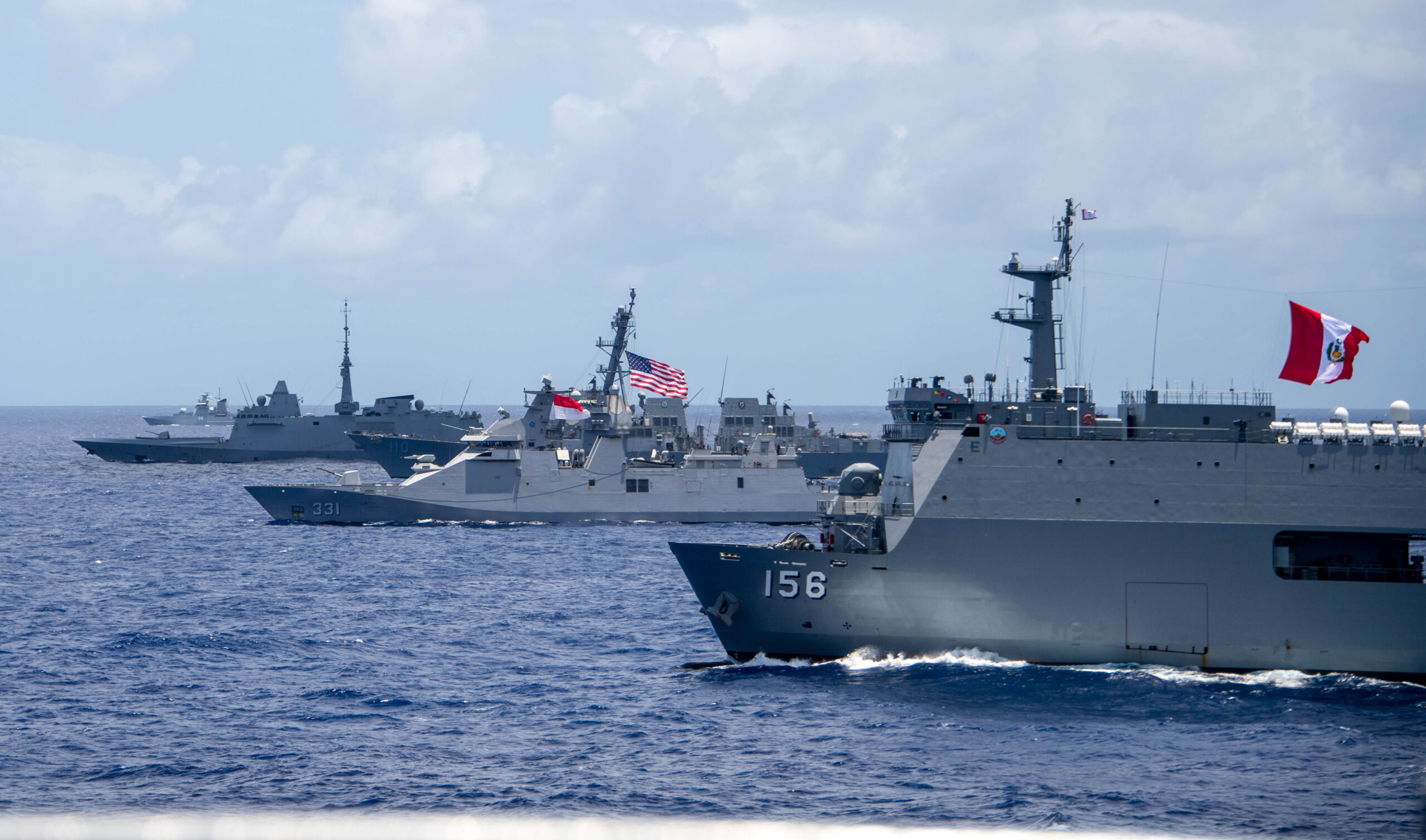 Multinational ships sail in formation during RIMPAC 2024 Comparative